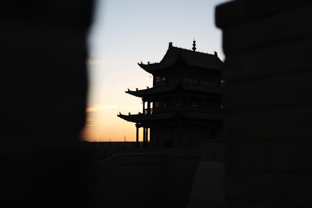 (260806) -- JIAYUGUAN, Aug. 6, 2026 (Xinhua) -- This photo taken on Aug. 5, 2026 shows a view of the Jiayu Pass at sunset in the city of Jiayuguan, northwest China's Gansu Province. The Jiayu Pass is the starting point of a section of the Great Wall constructed during the Ming Dynasty (1368-1644). The pass also served as a vital passage on the ancient Silk Road. (Xinhua/Chen Bin)