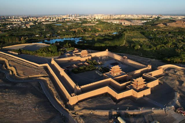 (260806) -- JIAYUGUAN, Aug. 6, 2026 (Xinhua) -- An aerial drone photo taken on Aug. 5, 2026 shows a view of the Jiayu Pass at sunset in the city of Jiayuguan, northwest China's Gansu Province. The Jiayu Pass is the starting point of a section of the Great Wall constructed during the Ming Dynasty (1368-1644). The pass also served as a vital passage on the ancient Silk Road. (Xinhua/Chen Bin)