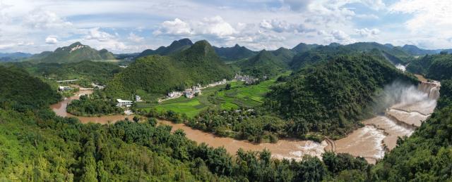 (260806) -- LUOPING, Aug. 6, 2026 (Xinhua) -- An aerial drone photo taken on Aug. 5, 2026 shows a panoramic view of the Jiulong Waterfalls in Luoping County, southwest China's Yunnan Province. Due to continuous heavy rainfall, the Jiulong Waterfalls in Luoping County have entered their high-flow season. (Photo by Mao Hong/Xinhua)