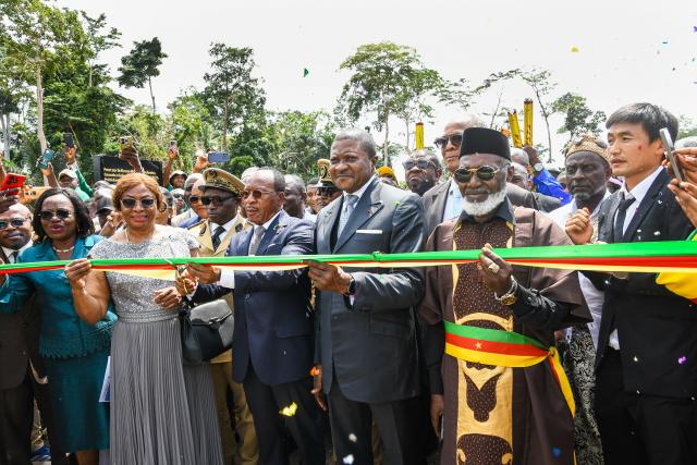 (260806) -- YAOUNDE, Aug. 6, 2026 (Xinhua) -- Minister of Public Works Emmanuel Nganou Djoumessi (3rd L, front) and guests cut a ribbon to inaugurate the Nyong River Bridge in the Nyong-et-Kelle division of Center Region, Cameroon, Aug. 5, 2026. The Nyong River Bridge at Malombo was inaugurated by Minister of Public Works Emmanuel Nganou Djoumessi. It was built by China First Highway Engineering Co., Ltd. (CFHEC). The 160-meter-long bridge spans the Nyong River and is supported by 960 meters of access roads. (Xinhua/Jean Pierre Kepseu)