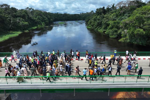 (260806) -- YAOUNDE, Aug. 6, 2026 (Xinhua) -- An aerial drone photo taken on Aug. 5, 2026 shows people walking on the Nyong River Bridge in the Nyong-et-Kelle division of Center Region, Cameroon. The Nyong River Bridge at Malombo was inaugurated by Minister of Public Works Emmanuel Nganou Djoumessi. It was built by China First Highway Engineering Co., Ltd. (CFHEC). The 160-meter-long bridge spans the Nyong River and is supported by 960 meters of access roads. (Xinhua/Jean Pierre Kepseu)