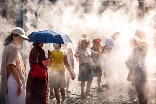 (260806) -- BUDAPEST, Aug. 6, 2026 (Xinhua) -- People cool off under a misting system in Budapest, Hungary, Aug. 6, 2026. Hungarian authorities on Tuesday extended the country's highest-level heat alert until midnight on Friday as forecasts indicate the ongoing heatwave will continue across the country. (Photo by David Balogh/Xinhua)