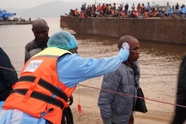 (260807) -- KINSHASA, Aug. 7, 2026 (Xinhua) -- A staff member of the International Organization for Migration (IOM) takes temperature of a passenger from an intercepted boat outside Kinshasa, capital of the Democratic Republic of the Congo (DRC), Aug. 6, 2026. Health authorities in the DRC have intercepted a passenger boat outside Kinshasa following the death of a former passenger suspected of having Ebola, officials said Wednesday. (Xinhua)