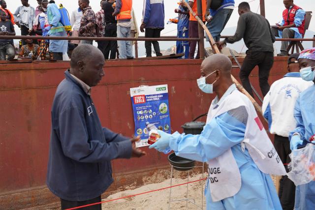 (260807) -- KINSHASA, Aug. 7, 2026 (Xinhua) -- Health officers distribute food to passengers from an intercepted boat outside Kinshasa, capital of the Democratic Republic of the Congo (DRC), Aug. 6, 2026. Health authorities in the DRC have intercepted a passenger boat outside Kinshasa following the death of a former passenger suspected of having Ebola, officials said Wednesday. (Xinhua)
