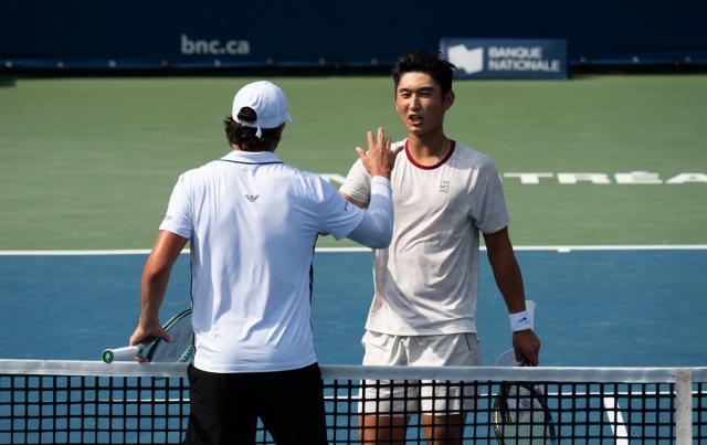 (260807) -- MONTREAL, Aug. 7, 2026 (Xinhua) -- Shang Juncheng (R) greets with Luciano Darderi after the men's singles third round match between Shang Juncheng of China and Luciano Darderi of Italy at the 2026 National Bank Open tennis tournament in Montreal, Canada, Aug. 6, 2026. (Photo by Li Haitao/Xinhua)