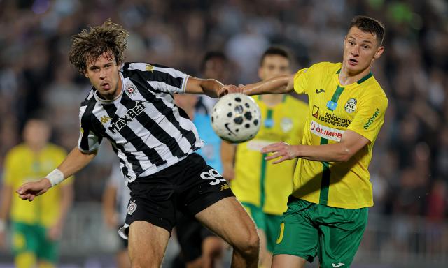 (260807) -- BELGRADE, Aug. 7, 2026 (Xinhua) -- Partizan's Bogdan Kostic (L) vies with Tobol's Islam Chesnokov during the third qualifying round 1st leg football match between Partizan and Tobol at the UEFA Conference League 2026/27 in Belgrade, Serbia on Aug. 6, 2026. (Photo by Predrag Milosavljevic/Xinhua)