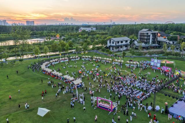 (260807) -- HEFEI, Aug. 7, 2026 (Xinhua) -- A drone photo taken on July 31, 2026 shows a view of a grape-themed market in Dawei Town of Hefei, east China's Anhui Province. Recently, the city of Hefei in east China has held a series of themed markets which took advantage of local cultural and tourism resources to boost consumption.
   At Huiyuan Garden scenic area, a cultural market featuring creative products, folk songs and performances, fish-shaped lantern parades and local delicacies offers visitors an immersive experience of Anhui culture.
   In Dawei Town, a grape-themed market provides a platform for local farmers to promote agricultural products. Visitors can taste various varieties of grapes and grape-based drinks, purchase agricultural products with discounts, and participate in study tours.
   By integrating cultural experiences, leisure activities and consumption, these themed markets have succeeded in attracting visitors while creating new opportunities for local tourism and rural industries. (Photo by Fan Bowen/Xinhua)