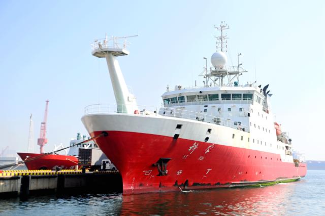 (260807) -- QINGDAO, Aug. 7, 2026 (Xinhua) -- A drone photo taken on Aug. 7, 2026 shows China's comprehensive research vessel KEXUE at a wharf base in Qingdao, east China's Shandong Province. KEXUE docked at a wharf base of the Institute of Oceanology under the Chinese Academy of Sciences on Friday, marking the conclusion of a shared research cruise in the western Pacific after a 35-day voyage covering 5,845 nautical miles. The data and samples obtained during the cruise will provide scientific support for more accurate typhoon forecasting and global climate change research. (Photo by Yu Fangping/Xinhua)