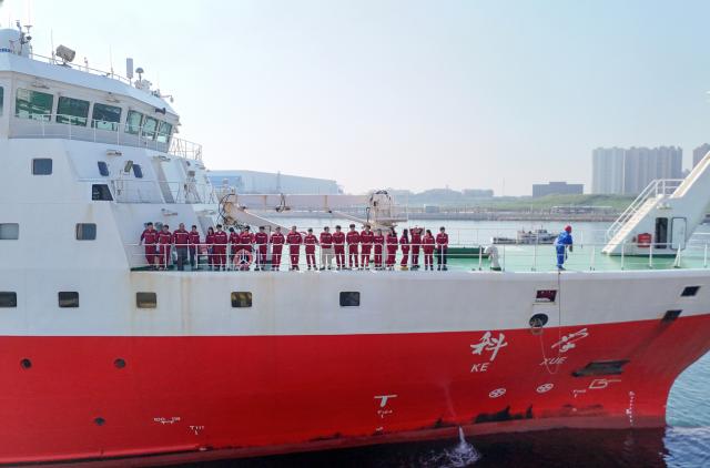 (260807) -- QINGDAO, Aug. 7, 2026 (Xinhua) -- A drone photo taken on Aug. 7, 2026 shows China's comprehensive research vessel KEXUE at a wharf base in Qingdao, east China's Shandong Province. KEXUE docked at a wharf base of the Institute of Oceanology under the Chinese Academy of Sciences on Friday, marking the conclusion of a shared research cruise in the western Pacific after a 35-day voyage covering 5,845 nautical miles. The data and samples obtained during the cruise will provide scientific support for more accurate typhoon forecasting and global climate change research. (Photo by Zhang Jingang/Xinhua)