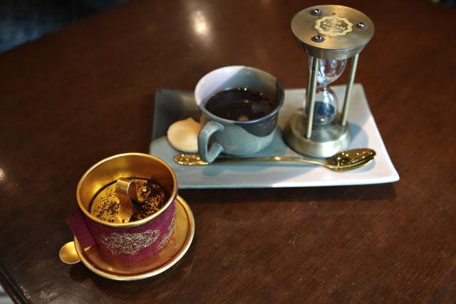 (260807) -- HANOI, Aug. 7, 2026 (Xinhua) -- This photo taken on Aug. 7, 2026 shows a cup of Vietnamese drip coffee with its metal filter in front of it in Hanoi, Vietnam. TO GO WITH "Feature: More than a drink: Coffee culture takes deeper root in Vietnamese life" (Xinhua/Liu Ying)