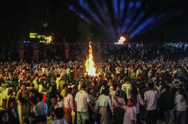 (260807) -- BEIJING, Aug. 7, 2026 (Xinhua) -- People attend a torch festival revelry in Yi-Hui-Miao Autonomous County of Weining, Bijie, southwest China's Guizhou Province, Aug. 6, 2026. The annual torch festivals were held in multiple locations on Thursday night, attracting crowds of tourists and locals from different ethnic groups. (Xinhua/Tao Liang)