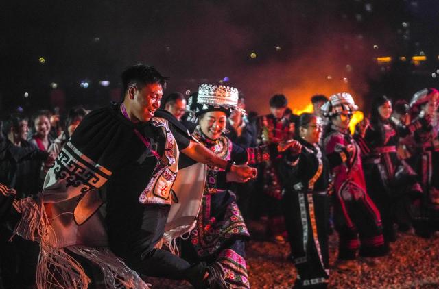 (260807) -- BEIJING, Aug. 7, 2026 (Xinhua) -- People sing and dance around bonfires during a torch festival revelry in Yi-Hui-Miao Autonomous County of Weining, Bijie, southwest China's Guizhou Province, Aug. 6, 2026. The annual torch festivals were held in multiple locations on Thursday night, attracting crowds of tourists and locals from different ethnic groups. (Xinhua/Tao Liang)