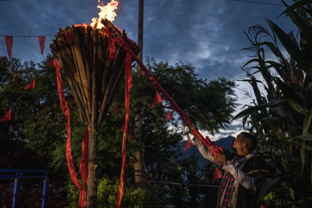 (260807) -- BEIJING, Aug. 7, 2026 (Xinhua) -- A villager lights a gigantic torch to celebrate the torch festival in Yongren County of Chuxiong Yi Autonomous Prefecture, southwest China's Yunnan Province, Aug. 6, 2026. The annual torch festivals were held in multiple locations on Thursday night, attracting crowds of tourists and locals from different ethnic groups. (Xinhua/Wang Guansen)