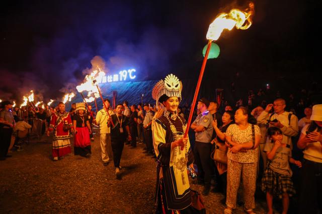 (260807) -- BEIJING, Aug. 7, 2026 (Xinhua) -- People celebrate the torch festival in Bijie, southwest China's Guizhou Province, Aug. 6, 2026. The annual torch festivals were held in multiple locations on Thursday night, attracting crowds of tourists and locals from different ethnic groups. (Photo by Li Hua/Xinhua)