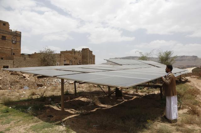 (260807) -- SANAA, Aug. 7, 2026 (Xinhua) -- A farmer turns solar panels toward the sun for grape irrigation in Bani Hushaysh, northeast of Sanaa, Yemen, Aug. 6, 2026.
  TO GO WITH "Feature: A lifeline, but no cure -- solar power becomes bitter choice for Yemeni grape growers" (Photo by Mohammed Mohammed/Xinhua)