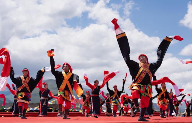 (260807) -- GARZE, Aug. 7, 2026 (Xinhua) -- People perform Guozhuang dance, a traditional Tibetan square dance, at the opening ceremony of the tent festival in Shiqu County of Garze Tibetan Autonomous Prefecture, southwest China's Sichuan Province, Aug. 7, 2026. A tent festival kicked off here on Friday. During the festival, local residents and tourists gather together, setting up tents and enjoying activities including horse racing, singing and dancing performances, and traditional sports competitions. (Xinhua/Jiang Hongjing)