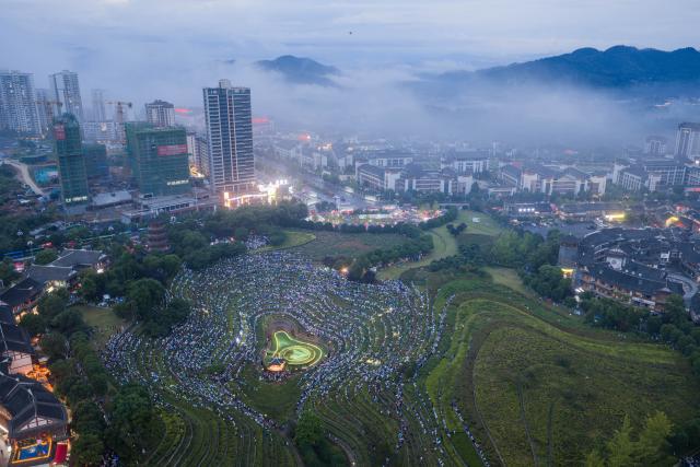 (260807) -- BIJIE, Aug. 7, 2026 (Xinhua) -- An aerial drone photo taken on Aug. 7, 2026 shows a concert held on the terraced field in Shexiang ancient town of Dafang County in Bijie, southwest China's Guizhou Province. (Photo by Luo Dafu/Xinhua)