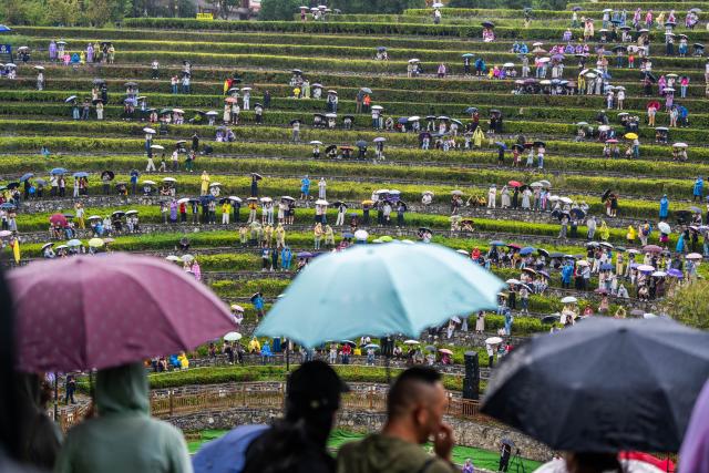 (260807) -- BIJIE, Aug. 7, 2026 (Xinhua) -- People enjoy a concert held on the terraced field in Shexiang ancient town of Dafang County in Bijie, southwest China's Guizhou Province, Aug. 7, 2026. (Photo by Luo Dafu/Xinhua)