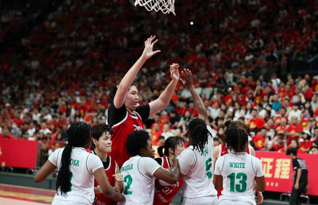 (260807) -- HAIKOU, Aug. 7, 2026 (Xinhua) -- Zhang Ziyu (top) of China competes during a friendly basketball match between China and Nigeria held in Haikou, south China's Hainan Province, Aug. 7, 2026. (Xinhua/Yang Guanyu)