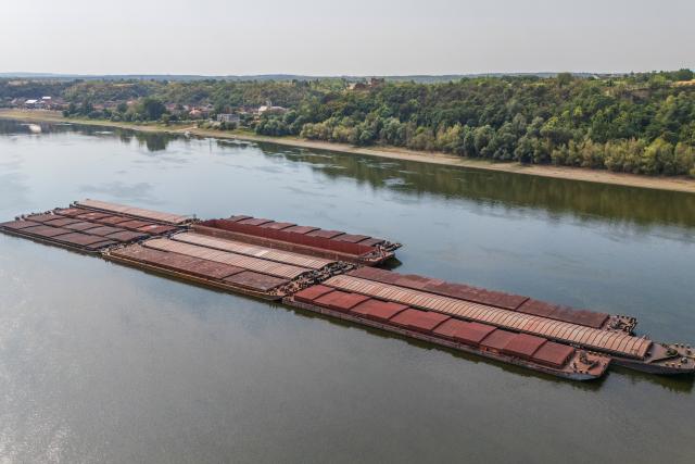 (260807) -- ZAGREB, Aug. 7, 2026 (Xinhua) -- This drone photo taken on Aug. 7, 2026 shows stranded cargo ships on the Danube river near Sarengrad, Croatia. Shipping on the Danube was severely affected by historically low water levels of the river. (David Jerkovic/PIXSELL via Xinhua)