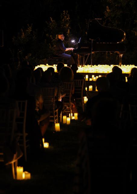 (260808) -- ROME, Aug. 8, 2026 (Xinhua) -- A pianist performs during the Candlelight Open Air concert at Villa Appia Antica in Rome, Italy, Aug. 7, 2026. Candlelight Open Air concert is a series of live musical performances held at iconic venues, including historic buildings, theaters, and monuments, illuminated by thousands of candles that create an intimate and special atmosphere. (Xinhua/Wang Kaiyan)