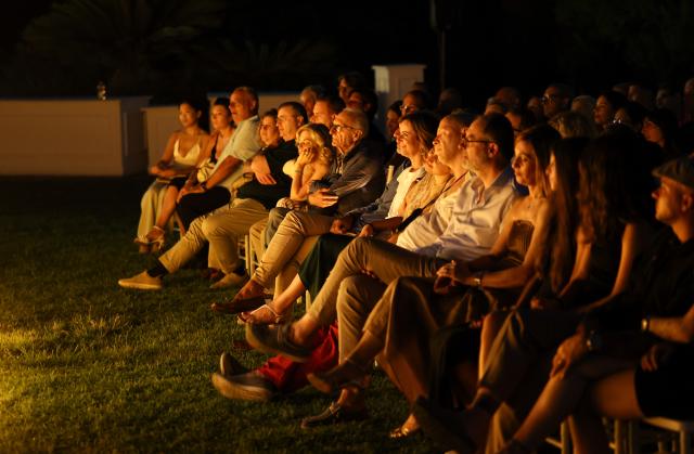 (260808) -- ROME, Aug. 8, 2026 (Xinhua) -- Spectators enjoy the Candlelight Open Air concert at Villa Appia Antica in Rome, Italy, Aug. 7, 2026. Candlelight Open Air concert is a series of live musical performances held at iconic venues, including historic buildings, theaters, and monuments, illuminated by thousands of candles that create an intimate and special atmosphere. (Xinhua/Wang Kaiyan)