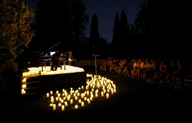 (260808) -- ROME, Aug. 8, 2026 (Xinhua) -- This photo taken on Aug. 7, 2026 shows a view at the Candlelight Open Air concert at Villa Appia Antica in Rome, Italy. Candlelight Open Air concert is a series of live musical performances held at iconic venues, including historic buildings, theaters, and monuments, illuminated by thousands of candles that create an intimate and special atmosphere. (Xinhua/Wang Kaiyan)