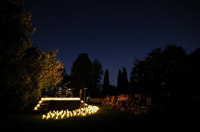 (260808) -- ROME, Aug. 8, 2026 (Xinhua) -- This photo taken on Aug. 7, 2026 shows a view at the Candlelight Open Air concert at Villa Appia Antica in Rome, Italy. Candlelight Open Air concert is a series of live musical performances held at iconic venues, including historic buildings, theaters, and monuments, illuminated by thousands of candles that create an intimate and special atmosphere. (Xinhua/Wang Kaiyan)