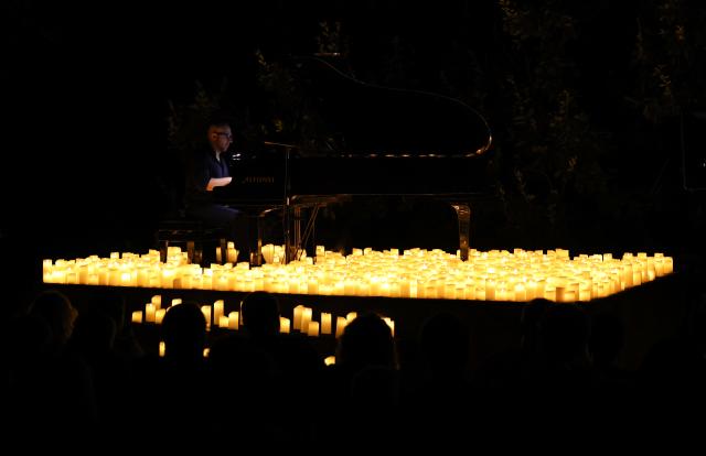 (260808) -- ROME, Aug. 8, 2026 (Xinhua) -- A pianist performs during the Candlelight Open Air concert at Villa Appia Antica in Rome, Italy, Aug. 7, 2026. Candlelight Open Air concert is a series of live musical performances held at iconic venues, including historic buildings, theaters, and monuments, illuminated by thousands of candles that create an intimate and special atmosphere. (Xinhua/Wang Kaiyan)