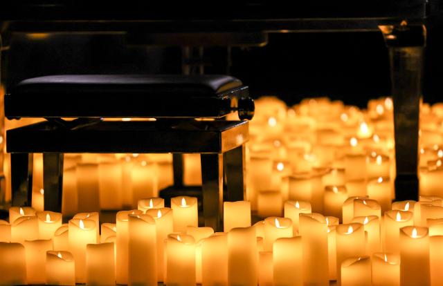 (260808) -- ROME, Aug. 8, 2026 (Xinhua) -- This photo taken on Aug. 7, 2026 shows a piano and a piano bench surrounded by candles before the Candlelight Open Air concert at Villa Appia Antica in Rome, Italy. Candlelight Open Air concert is a series of live musical performances held at iconic venues, including historic buildings, theaters, and monuments, illuminated by thousands of candles that create an intimate and special atmosphere. (Xinhua/Wang Kaiyan)