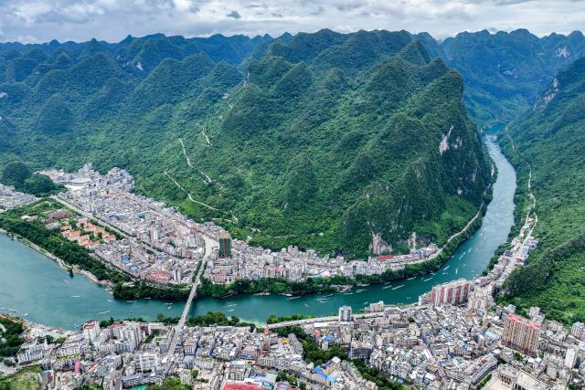 (260808) -- NANNING, Aug. 8, 2026 (Xinhua) -- An aerial drone photo taken on Aug. 4, 2026 shows a view of Tian'e County, south China's Guangxi Zhuang Autonomous Region. TO GO WITH "Letter from China: Paddleboarding boom in south China karst county" (Xinhua/Cao Yiming)