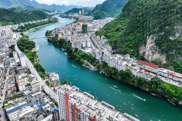 (260808) -- NANNING, Aug. 8, 2026 (Xinhua) -- An aerial drone photo taken on Aug. 5, 2026 shows people experiencing water sports in Tian'e County, south China's Guangxi Zhuang Autonomous Region. TO GO WITH "Letter from China: Paddleboarding boom in south China karst county" (Xinhua/Cao Yiming)