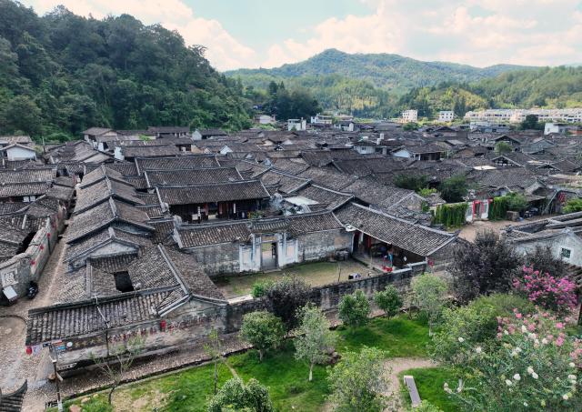 (260808) -- LONGYAN, Aug. 8, 2026 (Xinhua) -- A drone photo taken on Aug. 5, 2026 shows historical buildings at Peitian Village, Xuanhe Town, Liancheng County, Longyan City, southeast China's Fujian Province. Boasting a history of more than 800 years, Peitian Village is home to a complex of buildings from the Ming (1368-1644) and Qing (1644-1911) dynasties, as well as over 20 key cultural relic sites under state-level protection. It was listed as one of China's historic and cultural villages in 2005 and inscribed in the first batch of traditional Chinese villages catalog in 2012. Local authorities have injected new vitality into the village through efforts of integrated cultural and tourism development. (Xinhua/Lin Shanchuan)