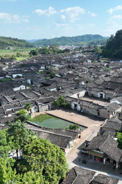 (260808) -- LONGYAN, Aug. 8, 2026 (Xinhua) -- A drone photo taken on Aug. 5, 2026 shows a complex of historical buildings at Peitian Village, Xuanhe Town, Liancheng County, Longyan City, southeast China's Fujian Province. Boasting a history of more than 800 years, Peitian Village is home to a complex of buildings from the Ming (1368-1644) and Qing (1644-1911) dynasties, as well as over 20 key cultural relic sites under state-level protection. It was listed as one of China's historic and cultural villages in 2005 and inscribed in the first batch of traditional Chinese villages catalog in 2012. Local authorities have injected new vitality into the village through efforts of integrated cultural and tourism development. (Xinhua/Lin Shanchuan)