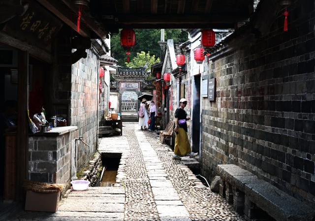 (260808) -- LONGYAN, Aug. 8, 2026 (Xinhua) -- Tourists visit Peitian Village in Xuanhe Town, Liancheng County, Longyan City, southeast China's Fujian Province, Aug. 5, 2026. Boasting a history of more than 800 years, Peitian Village is home to a complex of buildings from the Ming (1368-1644) and Qing (1644-1911) dynasties, as well as over 20 key cultural relic sites under state-level protection. It was listed as one of China's historic and cultural villages in 2005 and inscribed in the first batch of traditional Chinese villages catalog in 2012. Local authorities have injected new vitality into the village through efforts of integrated cultural and tourism development. (Xinhua/Lin Shanchuan)