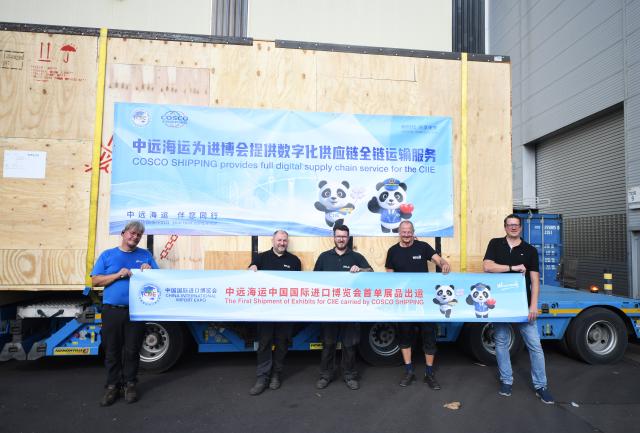 (260808) -- LINZ, Aug. 8, 2026 (Xinhua) -- Staff members pose for a group photo with exhibit products of WFL Millturn Technologies to be shipped in Linz, Austria, Aug. 7, 2026. Exhibit products from WFL Millturn Technologies in Linz, Austria, began their journey to Shanghai on Friday, marking the shipment of the first batch of exhibits for the 9th China International Import Expo (CIIE) this year.
   This year's CIIE is scheduled for Nov. 5-10. (Xinhua/He Canling)