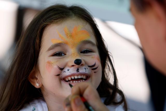 (260808) -- BUCHAREST, Aug. 8, 2026 (Xinhua) -- A child has her face colored like a lion during an event marking the upcoming World Lion Day at Bucharest Zoo in Bucharest, Romania, Aug. 8, 2026. World Lion Day is observed on Aug. 10 every year to raise people's awareness of lion conservation. (Photo by Cristian Cristel/Xinhua)