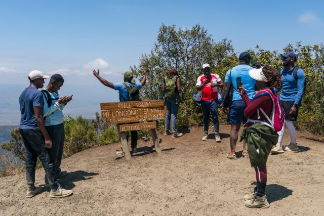 (260808) -- NAKURU, Aug. 8, 2026 (Xinhua) -- Tourists take photos at the summit of Mount Longonot in Nakuru, Kenya, Aug. 8, 2026. Mount Longonot National Park is located in Nakuru County in central Kenya, in the Great Rift Valley. Established in 1983, the park covers an area of about 52 square kilometers. Centered around the dormant Mount Longonot volcano, the park features a hiking trail around the volcanic crater and is a renowned destination in Kenya for its volcanic landscape and hiking. (Xinhua/Xie Jianfei)