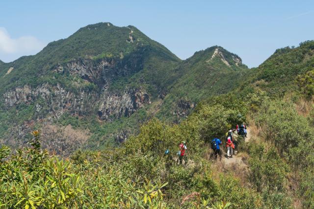 (260808) -- NAKURU, Aug. 8, 2026 (Xinhua) -- Tourists hike around the volcanic crater at Mount Longonot National Park in Nakuru, Kenya, Aug. 8, 2026. Mount Longonot National Park is located in Nakuru County in central Kenya, in the Great Rift Valley. Established in 1983, the park covers an area of about 52 square kilometers. Centered around the dormant Mount Longonot volcano, the park features a hiking trail around the volcanic crater and is a renowned destination in Kenya for its volcanic landscape and hiking. (Xinhua/Xie Jianfei)