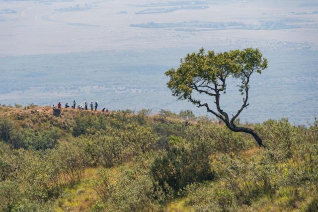 (260808) -- NAKURU, Aug. 8, 2026 (Xinhua) -- Tourists rest during a hike around the volcanic crater at Mount Longonot National Park in Nakuru, Kenya, Aug. 8, 2026. Mount Longonot National Park is located in Nakuru County in central Kenya, in the Great Rift Valley. Established in 1983, the park covers an area of about 52 square kilometers. Centered around the dormant Mount Longonot volcano, the park features a hiking trail around the volcanic crater and is a renowned destination in Kenya for its volcanic landscape and hiking. (Xinhua/Xie Jianfei)