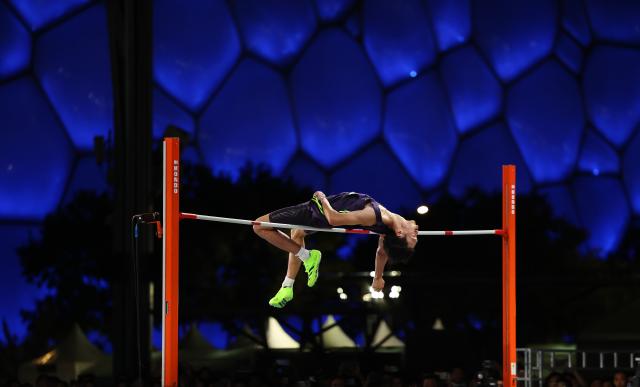(260809) -- BEIJING, Aug. 9, 2026 (Xinhua) -- He Yifan of Jiangsu competes during the men's high jump competition of China Athletics Street Tour (CAST) in front of the National Aquatics Center in Beijing, capital of China, Aug. 8, 2026. (Xinhua/Li Ming)