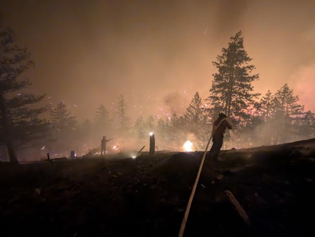 (260809) -- OTTAWA, Aug. 9, 2026 (Xinhua) -- This photo provided by the BC Wildfire Service on Aug. 8, 2026 shows firefighters putting out a wildfire near Okanagan Valley in the Southern Interior of British Columbia, Canada. The western Canadian province of British Columbia (B.C.) declared a provincial state of emergency on Saturday as fast-spreading wildfires threatened several communities. (BC Wildfire Service/Handout via Xinhua)