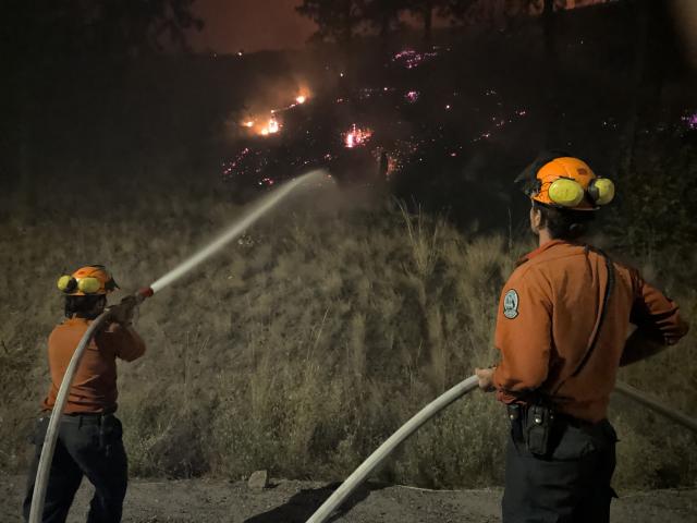 (260809) -- OTTAWA, Aug. 9, 2026 (Xinhua) -- This photo provided by the BC Wildfire Service on Aug. 8, 2026 shows firefighters putting out a wildfire near Okanagan Valley in the Southern Interior of British Columbia, Canada. The western Canadian province of British Columbia (B.C.) declared a provincial state of emergency on Saturday as fast-spreading wildfires threatened several communities. (BC Wildfire Service/Handout via Xinhua)