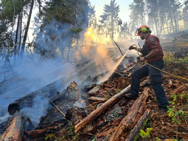 (260809) -- OTTAWA, Aug. 9, 2026 (Xinhua) -- This photo provided by the BC Wildfire Service on Aug. 8, 2026 shows a firefighter putting out a wildfire near Vernon in the Southern Interior of British Columbia, Canada. The western Canadian province of British Columbia (B.C.) declared a provincial state of emergency on Saturday as fast-spreading wildfires threatened several communities. (BC Wildfire Service/Handout via Xinhua)