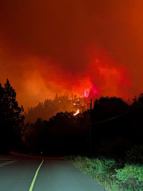 (260809) -- OTTAWA, Aug. 9, 2026 (Xinhua) -- This photo provided by the BC Wildfire Service on Aug. 7, 2026 shows a wildfire on a roadside near Okanagan Valley in the Southern Interior of British Columbia, Canada. The western Canadian province of British Columbia (B.C.) declared a provincial state of emergency on Saturday as fast-spreading wildfires threatened several communities. (BC Wildfire Service/Handout via Xinhua)