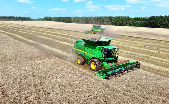 (260809) -- HARBIN, Aug. 9, 2026 (Xinhua) -- An aerial drone photo taken on Aug. 7, 2026 shows harvesters working at a wheat field of a farming company under Beidahuang Group in northeast China's Heilongjiang Province. (Photo by Ren Baoji/Xinhua)