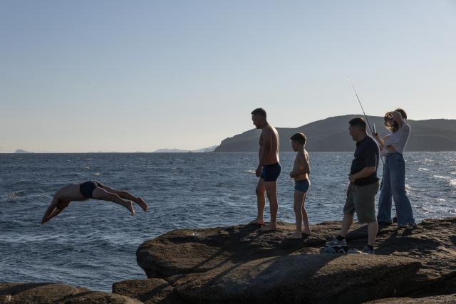 (260809) -- VLADIVOSTOK, Aug. 9, 2026 (Xinhua) -- A person jumps into the sea at Cape Tobizina in Vladivostok, Russia, Aug. 8, 2026. Located at the southernmost tip of Russky Island in Vladivostok, Cape Tobizina is a popular tourist destination. (Photo by Andrey Matveenko/Xinhua)