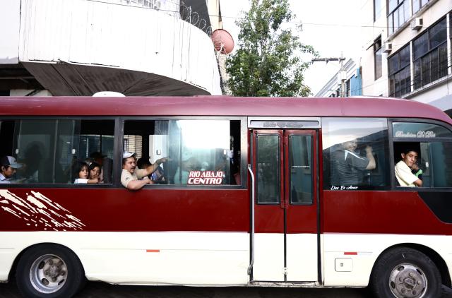 (260809) -- TEGUCIGALPA, Aug. 9, 2026 (Xinhua) -- People travel by bus in the old town of Tegucigalpa, Honduras, on Aug. 6, 2026. Tegucigalpa, the capital of Honduras, is the country's political and economic center. Surrounded by mountains and hills, the city is known for its hilly terrain, colorful streets and vibrant urban life. (Xinhua/Liu Wenhui)