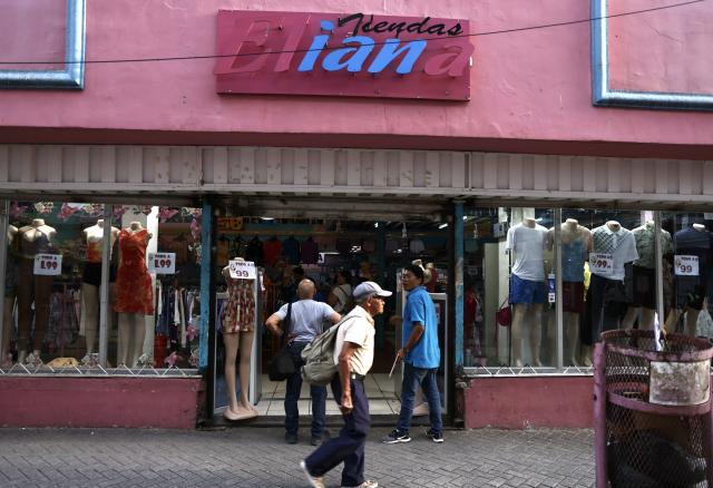 (260809) -- TEGUCIGALPA, Aug. 9, 2026 (Xinhua) -- This photo taken on Aug. 6, 2026 shows a clothing store in the old town of Tegucigalpa, Honduras. Tegucigalpa, the capital of Honduras, is the country's political and economic center. Surrounded by mountains and hills, the city is known for its hilly terrain, colorful streets and vibrant urban life. (Xinhua/Liu Wenhui)