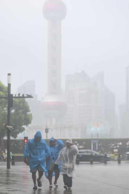 (260809) -- SHANGHAI, Aug. 9, 2026 (Xinhua) -- People walk amid rain at Huangpu District of Shanghai, east China, on Aug. 9, 2026. China's eastern metropolis Shanghai issued its highest rainstorm alert Sunday over rising risks of urban waterlogging brought by Typhoon Dolphin, the 13th typhoon of the year that has a great impact on the country's coastal regions.
   China's national observatory on Sunday activated a red alert -- the highest level in the country's typhoon warning system -- as Typhoon Dolphin approaches.
   Typhoon Dolphin is forecast to make landfall along the country's east coast from Sanmen in Zhejiang Province to Fuding in Fujian Province around Sunday evening to the early hours of Monday, according to the National Meteorological Center (NMC). (Xinhua/Wang Xiang)